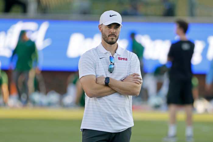 SMU offensive coordinator Garrett Riley watches players practice prior to playing Tulane during an NCAA college football game in Dallas, Thursday, Oct. 22, 2021. (AP Photo/Michael Ainsworth)